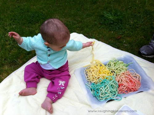 Baby playing with spaghetti