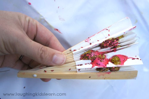 Squashing Paint on a fan for Chinese New Year craft