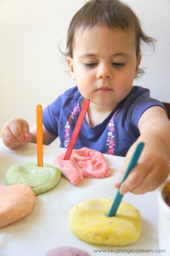Invitation to play and create using paddle pop sticks and play dough