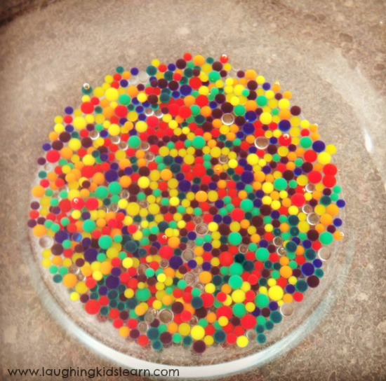 Adding water to water beads for sensory play