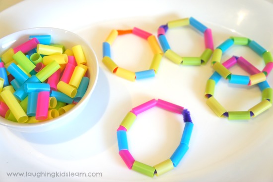 threading straw beads to make bracelets for kids