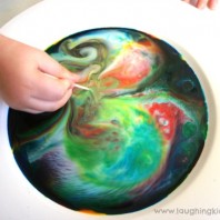mixing and changing colours in this magic milk science experiment for kids