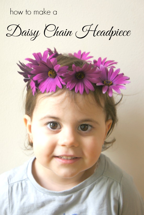 Daisy chain headpiece that is purple, and on a little girl's head.