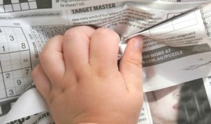 Fine motor exercise using newspaper