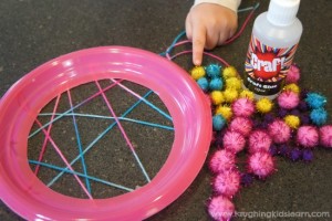 Plate dreamcatcher craft using pompoms from The Reject Shop