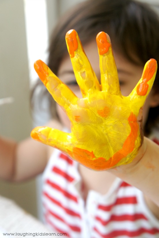 preschooler painting activity of painting hands and printing