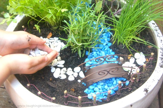 Adding stones to fairy garden