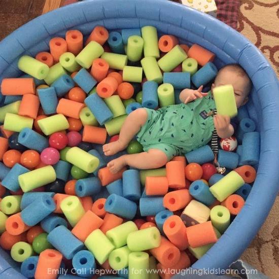 Baby and toddler play space using cut up pool noodles and balls