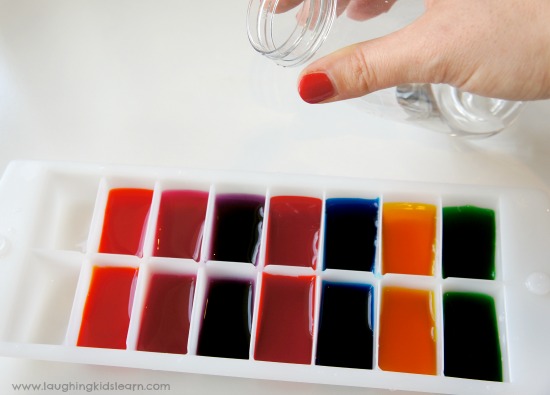 pouring water into ice trays for paint