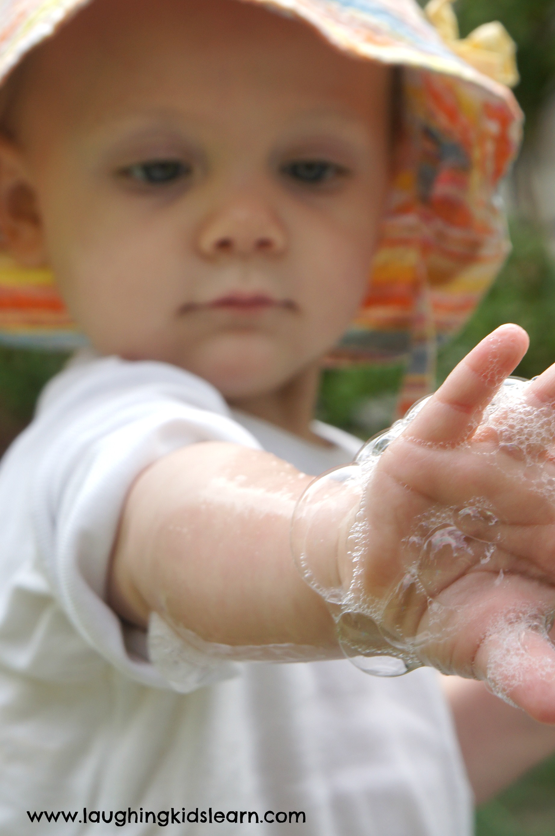 bubbles on child's arm for sensory play