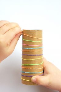 simple fine motor activity using a cardboard tube and elastic bands