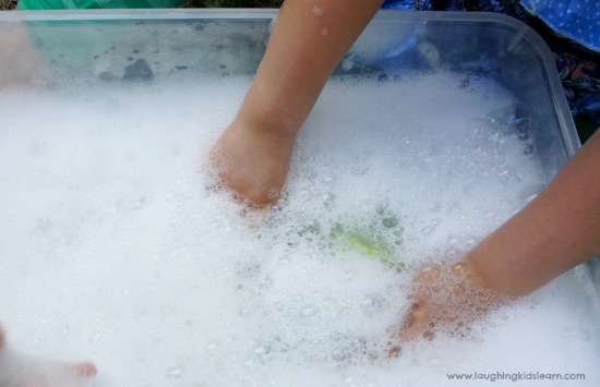 playing in soapy bubbles for sensory play