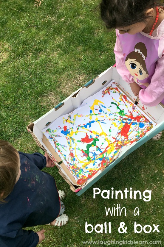 Kids painting together using a ball and a box