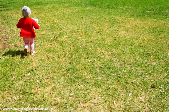 toddler outdoors exploring nature and doing scavenger hunt printable