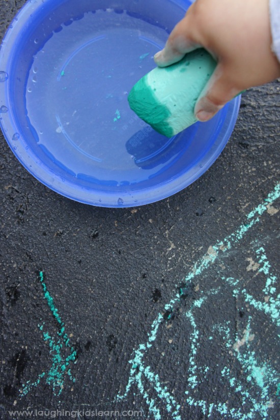 dipping chalk into water and painting