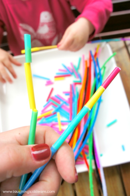 threading pipe cleaners onto straws for fun and fine motor development