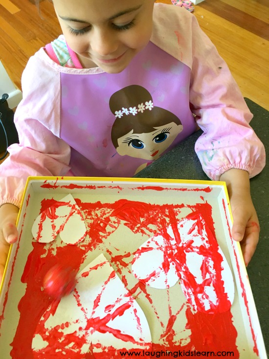 toddler or preschooler painting hearts for valentines day cards #valentinesday #kidsmaking #giftideasfromkids #lovetopaint #kidspainting #rollpaint #kidsplay #playmatters 