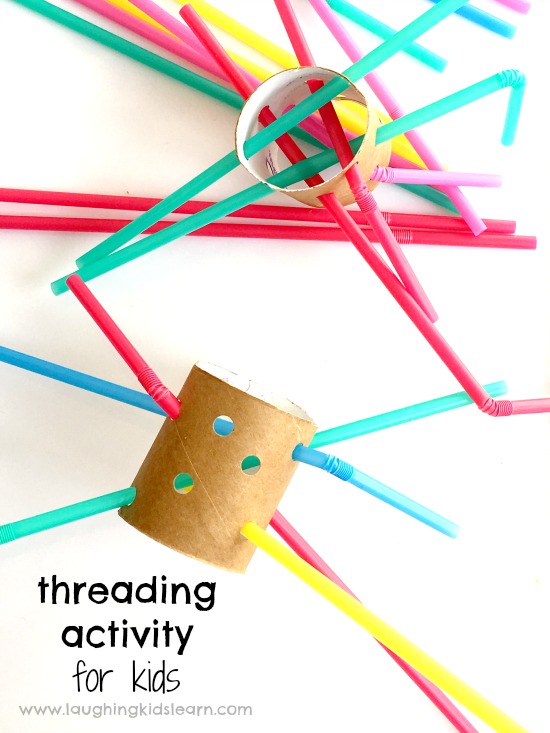 Fine motor threading activity using straws and cardboard tubes.