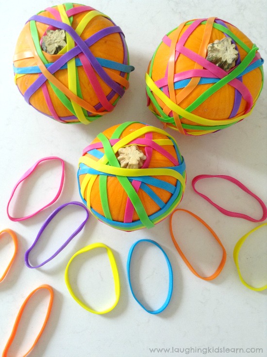 Putting elastic bands over pumpkins as a Halloween activity for just a simple fine motor activity to set up at home or school. #finemotorskills #finemotor #finemotoractivities #halloween #happyhalloween #kidshalloween #halloweenactivities #halloweenplayideas #minipumpkins #elasticbands #earlyyears #funathome #homeschool #preschool #preschooler #toddlers #toddlerplayideas #simpleplayideas #easyplayideas #playmatters #kbn #ots #ot #otactivities #lovetolearn 