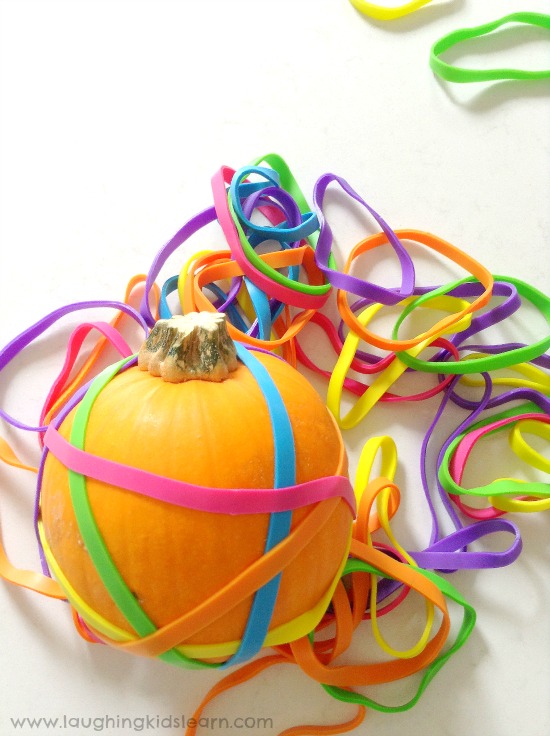 elastic bands over pumpkins as a Halloween activity for just a simple fine motor activity to set up at home or school. #finemotorskills #finemotor #finemotoractivities #halloween #happyhalloween #kidshalloween #halloweenactivities #halloweenplayideas #minipumpkins #elasticbands #earlyyears #funathome #homeschool #preschool #preschooler #toddlers #toddlerplayideas #simpleplayideas #easyplayideas #playmatters #kbn #ots #ot #otactivities #lovetolearn 