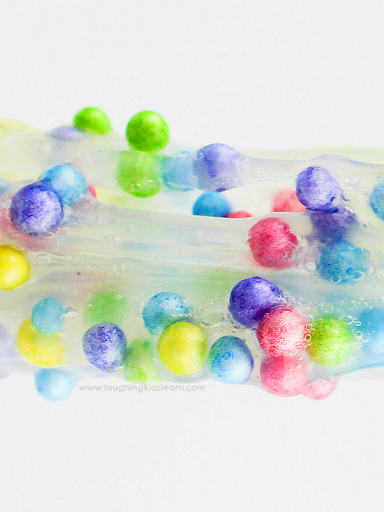 Slime recipe with foam balls is great for sensory play. Learn how to make it. #slime #sensoryslime #foamslime #slimerecipe #kidsscience #simpleslime #glueslime #elmerglue #makingslime #makeslime #recipeforslime #funslime #texturedslime #sensoryplay #sensoryprocessing #rainbowcolors #rainbowslime colorfulslime #easyslimerecipe #funslime #makeslime #styrofoamballs #stretchyslime #kbn #floam #funtomakeslime #threeingredients #simplerecipeforkids #kidsplay #messyplay #pastelcolors