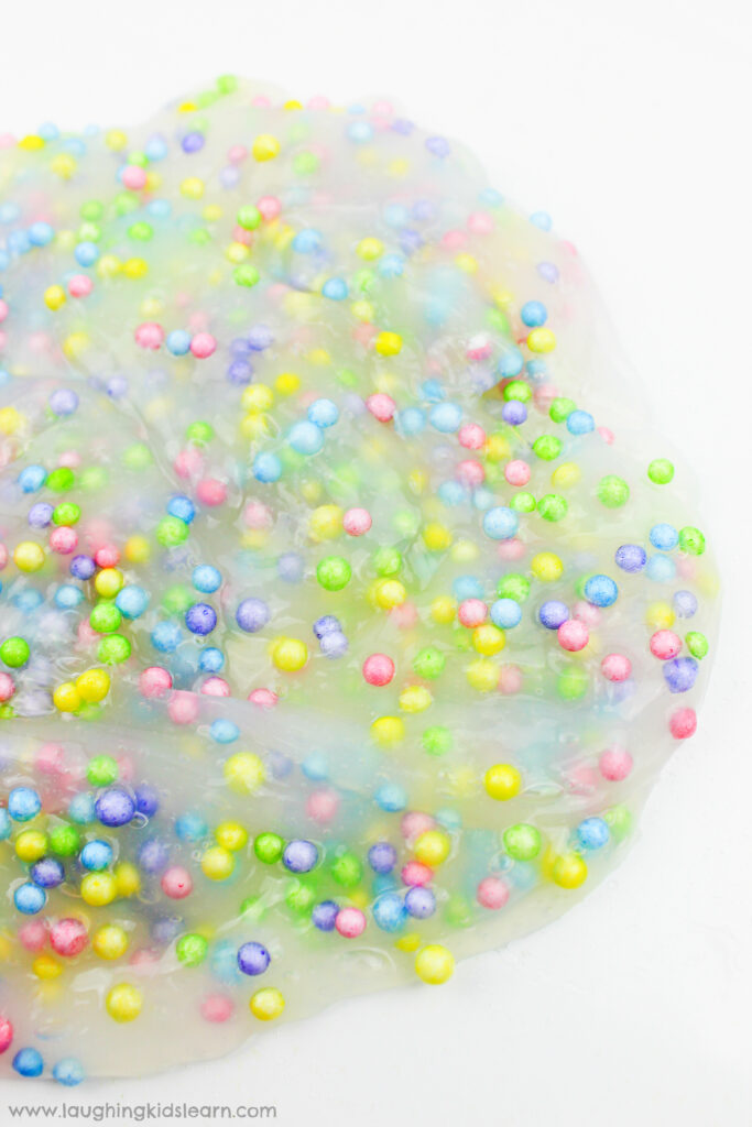 simple slime recipe with foam balls is great for sensory play. Learn how to make it. #slime #sensoryslime #foamslime #slimerecipe #kidsscience #simpleslime #glueslime #elmerglue #makingslime #makeslime #recipeforslime #funslime #texturedslime #sensoryplay #sensoryprocessing #rainbowcolors #rainbowslime colorfulslime #easyslimerecipe #funslime #makeslime #styrofoamballs #stretchyslime #kbn #floam #funtomakeslime #threeingredients #simplerecipeforkids #kidsplay #messyplay #pastelcolors