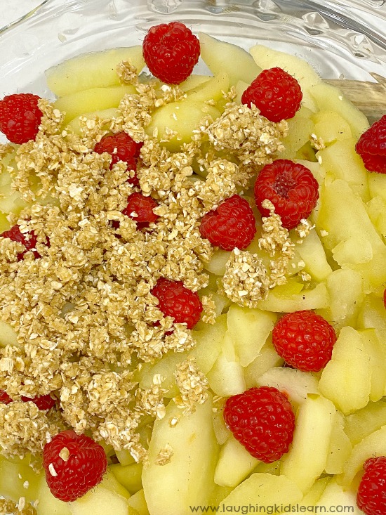 apple and raspberry crumble kids can make at home. Quick and easy dessert you can make with children. #applecrumble #kidscook #kidsrecipe #simplerecipeforkids #applecrumblerecipe #simpledessert #appleandraspberrycrumble #kidsinthekitchen #lovetocook #chefkids #simpledessert #familydessert #dessertrecipe #crumbledessert #quickandeasydessert #funathome #schoolholidays #holidaycooking #easyrecipe #simplerecipe #quickrecipe #lastminuterecipe #kbn 