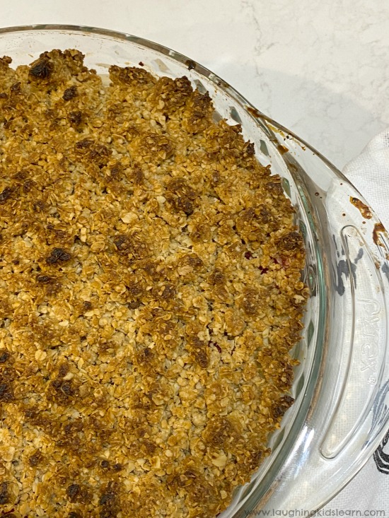 Delicious apple and raspberry crumble kids can make at home. Quick and easy dessert you can make with children. #applecrumble #kidscook #kidsrecipe #simplerecipeforkids #applecrumblerecipe #simpledessert #appleandraspberrycrumble #kidsinthekitchen #lovetocook #chefkids #simpledessert #familydessert #dessertrecipe #crumbledessert #quickandeasydessert #funathome #schoolholidays #holidaycooking #easyrecipe #simplerecipe #quickrecipe #lastminuterecipe #kbn 