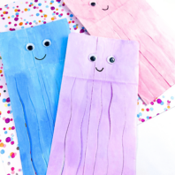Adorable paper bag jellyfish with rainbow-colored tentacles, a hit for kids' crafting on Pinterest.